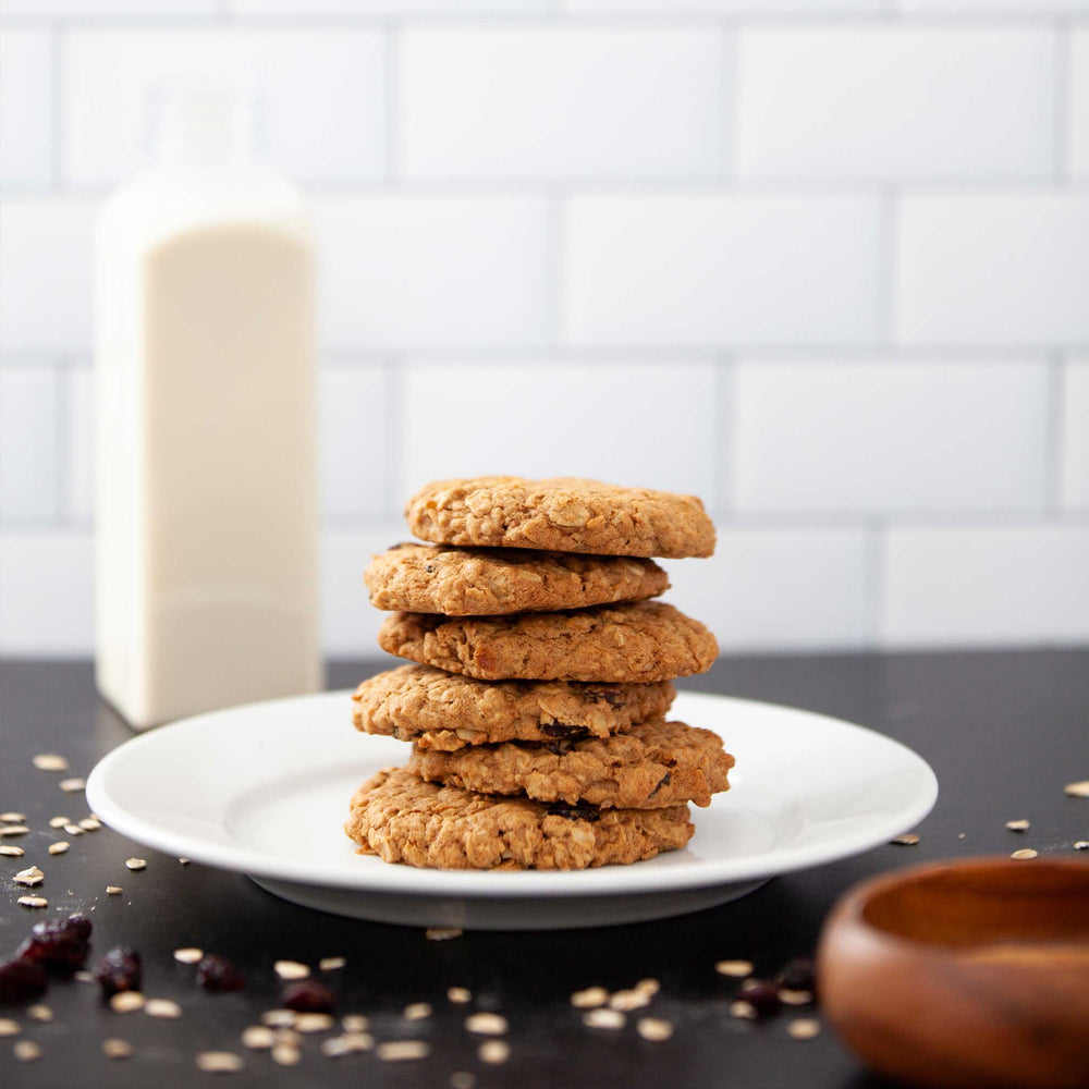 
                  
                    A photo of 6 oatmeal raisin cookies arranged in a vertical stack on top of a white plate.
                  
                